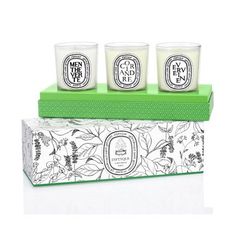 three candles sitting on top of a green box