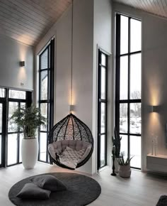 the instagram page shows an image of a living room with large windows and a hammock chair