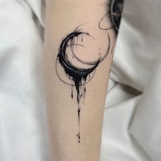 a black and white ink drawing on the leg of a person with a circular tattoo