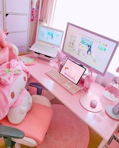 a pink hello kitty desk with two computers