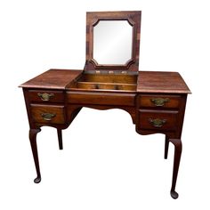 an antique wooden desk with mirror on top