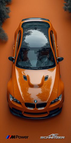 an orange sports car is shown from above