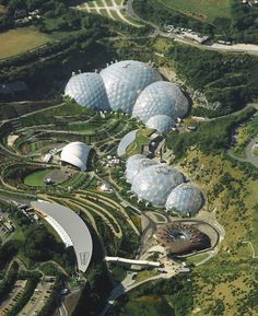 an aerial view of several large domes in a park