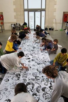 a group of people sitting at a long table with mickey mouse designs on it,