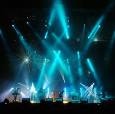 the stage is lit up with green and blue lights