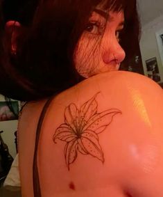 a woman with a flower tattoo on her shoulder