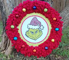 a christmas wreath with the grin face on it