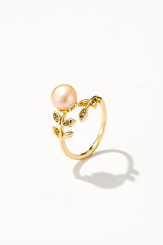 Make a statement with the Adjustable Pink Pearl Ring, where femininity meets elegance in a chic design. This ring features a delicate band adorned with a lustrous pink freshwater pearl, adding a pop of color to any ensemble. Crafted with versatility in mind, the adjustable band allows for a perfect fit on any finger. Whether you're dressing up for a special occasion or adding a touch of glamour to your everyday look, this ring is sure to turn heads. Pink Pearl Ring, Pearl Rings, Gemstone Earrings Gold, Pearl Gemstone, Pink Pearl, Pearl Ring, Cultured Pearls, Chic Design, Gemstone Earrings