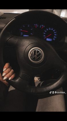 a woman is sitting behind the wheel of a car with her hands on the steering wheel