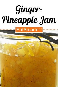 a glass jar filled with pineapple jam sitting on top of a table