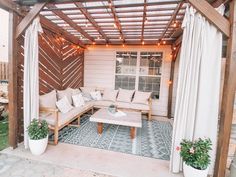 an outdoor living area with couches and lights