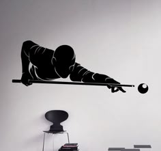 a black and white photo of a person doing a trick with a sticker on the wall