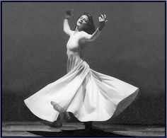 a black and white photo of a woman dancing