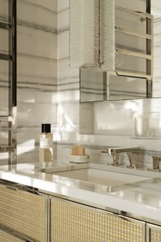 a bathroom sink sitting under a large mirror