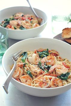 a white bowl filled with pasta and shrimp