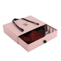 a pink box with some red hair in it