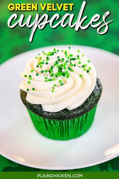 green velvet cupcakes with white frosting and sprinkles on a plate