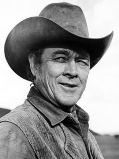 an old black and white photo of a man wearing a cowboy hat