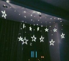 some white stars are hanging from the ceiling