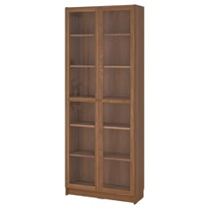 a wooden bookcase with glass doors on the front and bottom shelves in light brown