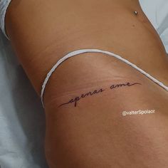 a woman laying on top of a bed wearing a white string around her waist with the word openas are written in cursive writing