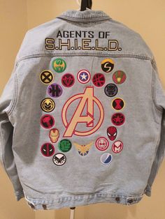 a denim jacket with avengers patches on it