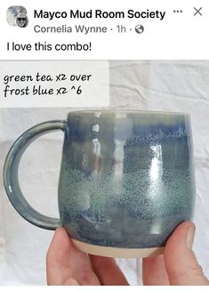 someone is holding up a coffee mug with blue glaze on the outside and inside