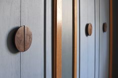 two wooden doors with knobs on them and one has an oval handle in the middle