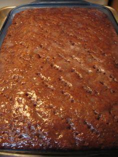 a cake in a pan sitting on top of a stove