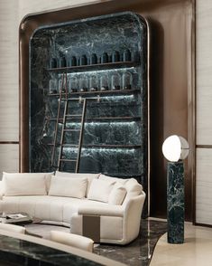 a living room filled with furniture and a marble wall mounted shelf next to a white couch