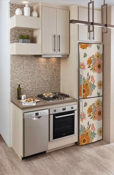 a modern kitchen with stainless steel appliances and white cupboards, beige tile backsplash