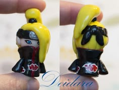 two small figurines in the shape of people with yellow hair and blue eyes