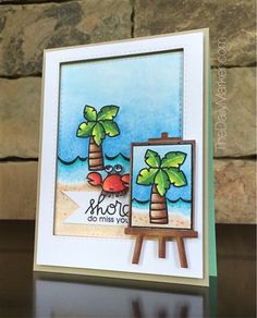 a handmade card with an easel and palm trees