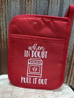 a red oven pot holder with the words when in doubt pull it out on it