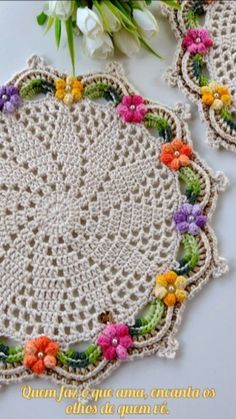 two crocheted doily with flowers on them