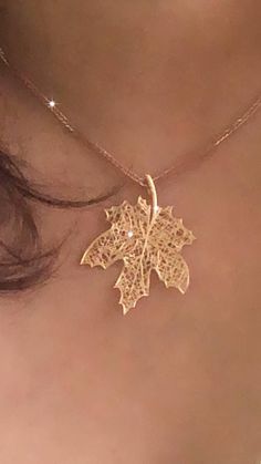 The iconic maple leaf, a symbol of strength and beauty, makes this piece not only a stylish accessory but also a meaningful one. Perfect for nature lovers or anyone seeking a unique, high-quality addition to their jewelry collection. Symbol Of Strength, Symbols Of Strength, Leaf Necklace, Leaf Pendant, Nature Lovers, Stylish Accessories, Maple Leaf, Gold Pendant, Pendant Necklaces