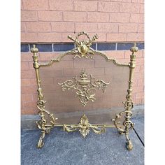 an ornate gold metal bed frame on the sidewalk