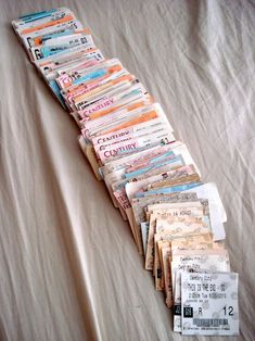 a pile of newspapers sitting on top of a bed