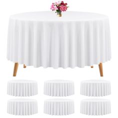 a table with white pleated cloths and pink flowers on top, all set up in the same row