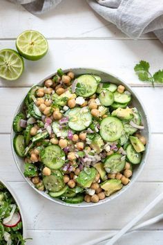 a bowl filled with cucumber, chickpeas and lettuce salad