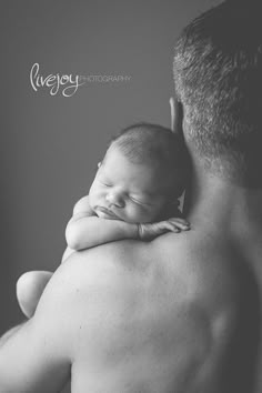 a man holding a baby in his arms