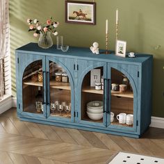 a blue cabinet with glass doors in a room