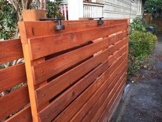 a wooden fence in front of a house