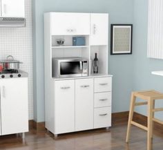 a kitchen with white cabinets and appliances in it