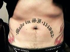 a man with a tattoo on his stomach has the words made in silver written below it