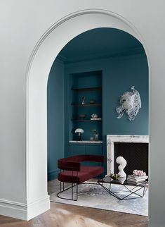 a living room with blue walls and furniture