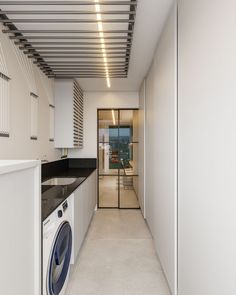 a laundry room with a washer and dryer next to the kitchen counter top