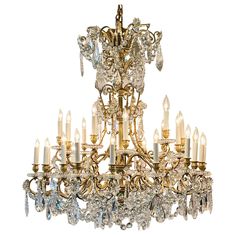 an antique chandelier with many crystal pieces on the bottom and sides, all in gold