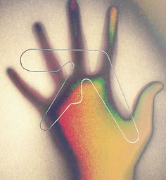 a person's hand is shown with colored lines in the shape of a wave