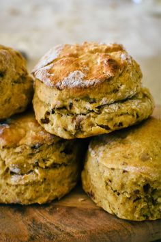 a pile of biscuits sitting on top of a wooden cutting board